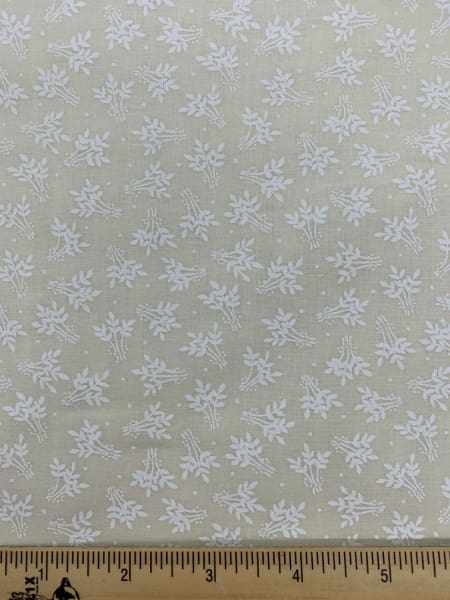 A white print of wheat on a cream background quilting fabric
