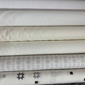 A pile of white quilting fabric