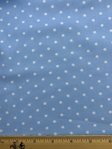 White spots on a pale blue background quilting fabric from Moda UK