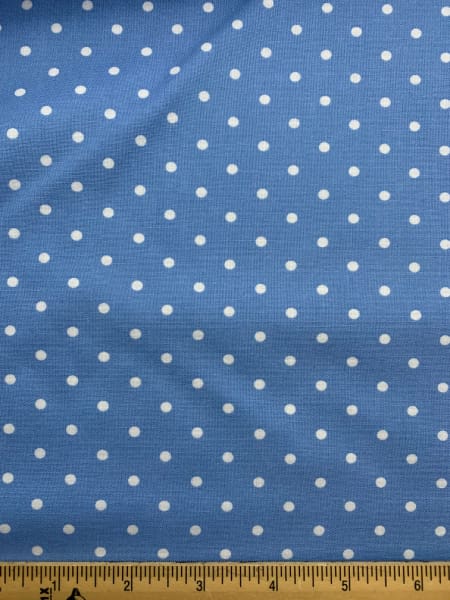 White spots on a mid blue background quilting fabric from Moda UK