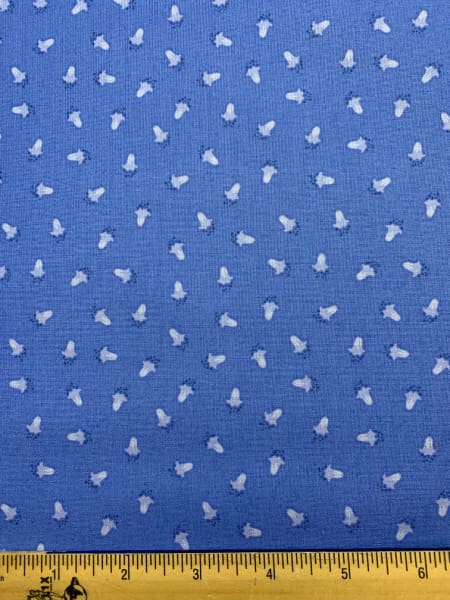 Scattered bluebells on blue quilting fabric from Bluebell woods by Lewis and Irene UK