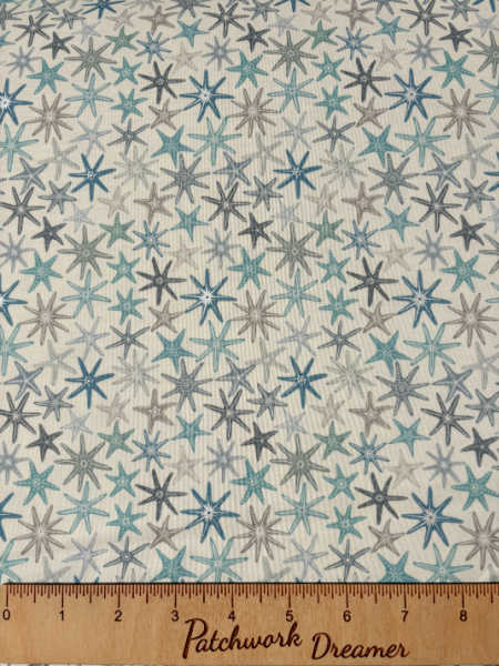 Multi starfish on cream with pearl quilting fabric from Lewis and Irene UK