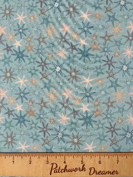 Multi starfish on pale blue with pearl quilting fabric from Lewis and Irene UK