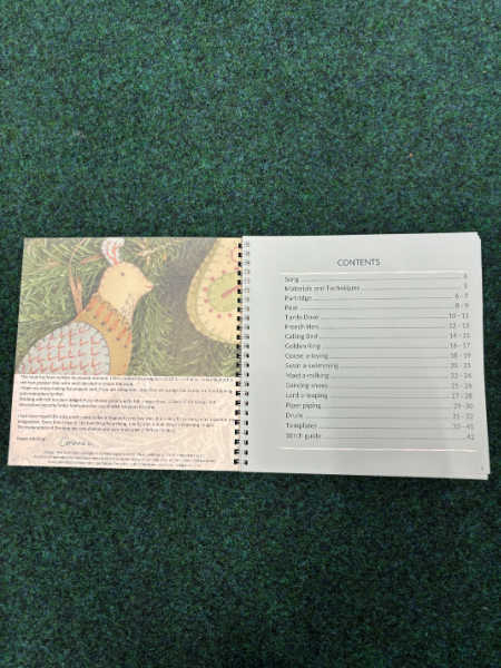 Open pages of 12 Days of Christmas Felt Decorations by Corinne Lapierre showing the contents list and an image of a stitched partridge felt ornament.