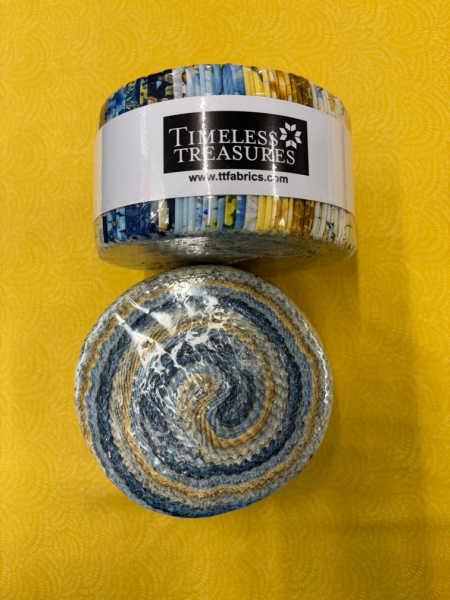 Timeless Treasures UK Bee Kind jelly roll showing blue, gold, and cream fabric strips rolled together with collection label.