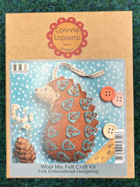 Corinne Lapierre Folk Embroidered Hedgehog felt kit showing a brown felt hedgehog decorated with blue and red embroidered details.