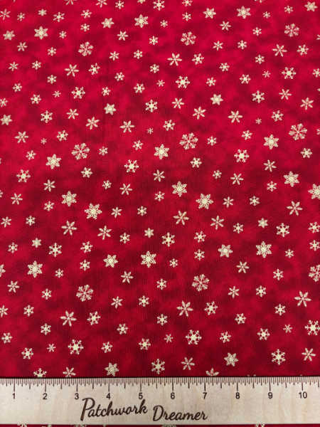 Christmas quilting fabric by Timeless Treasures UK – red with scattered golden snowflakes, 110cm wide, 100% cotton.