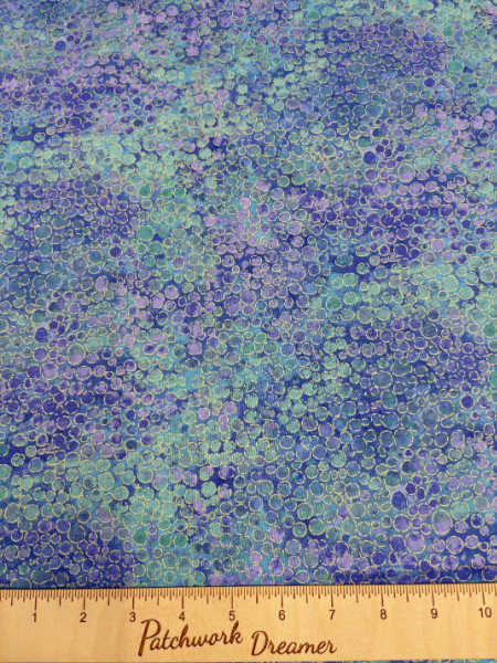 Northcott UK Shimmer Basics River Rocks in Deep Sea — purple, blue, and sea-green metallic pebble-texture quilting fabric