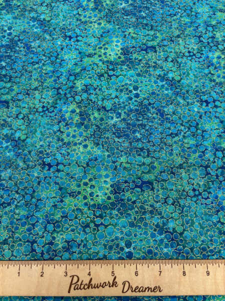 Northcott UK Shimmer Basics River Rocks in Lagoon bright teal and blue metallic pebble-texture quilting fabric.