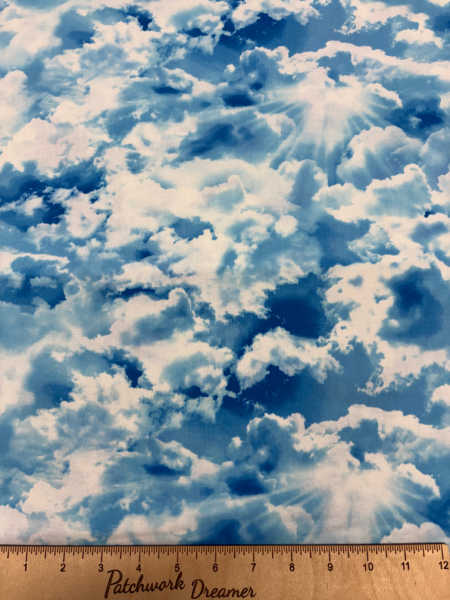 Timeless Treasures sky clouds quilting fabric in soft blue and cream, showing fluffy clouds and sunbeams – Patchwork Dreamer UK