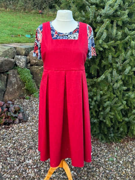 Red woven Popover Pinnyfore dress displayed on a mannequin at Patchwork Dreamer in the UK
