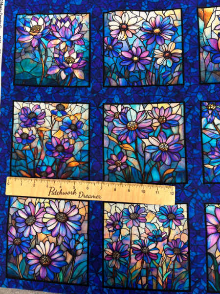 Mosaic Blooms quilting fabric panel close-up showing stained glass floral blocks in jewel tones