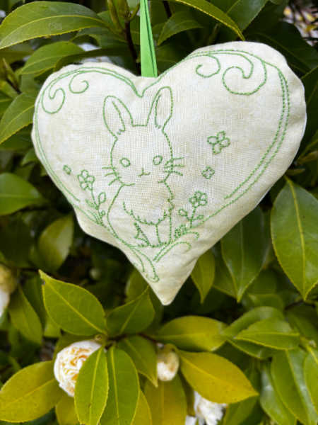 Green embroidered bunny heart hanging on a plant, backstitch embroidery kit finished example UK