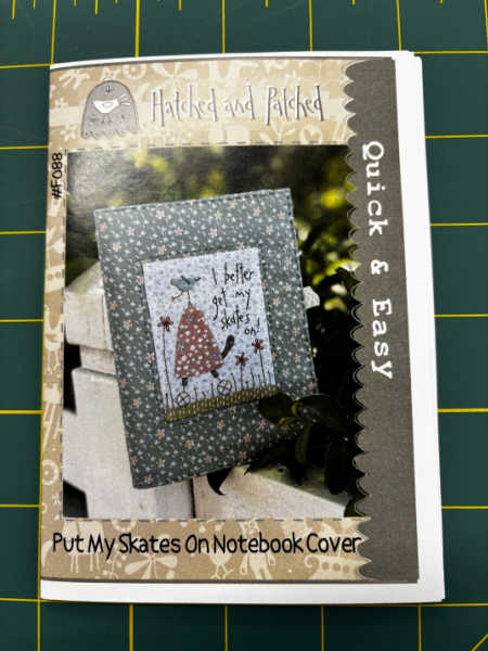 Put My Skates On notebook cover embroidery pattern by Hatched and Patched showing stitched notebook cover design UK