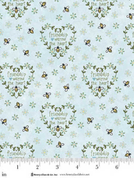 Blue fabric with floral heart wreaths bees and friendship warms the heart text Henry Glass UK