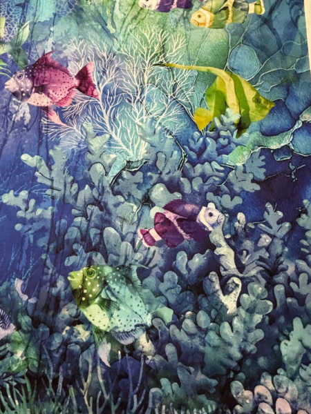 Close up of Coral Reef by Northcott quilting fabric panel showing tropical fish and blue coral reef