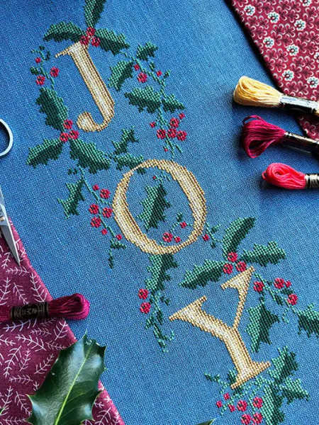 Love Poppet UK JOY holly counted cross stitch design on dusty blue linen