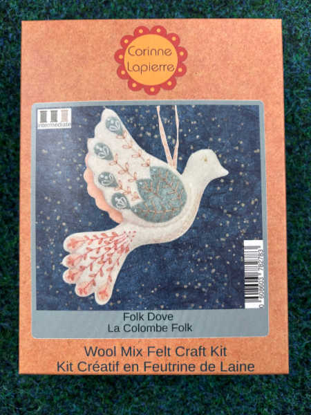 Corinne Lapierre Folk Dove felt kit showing a cream hanging dove with a soft green wing and peach floral embroidery.